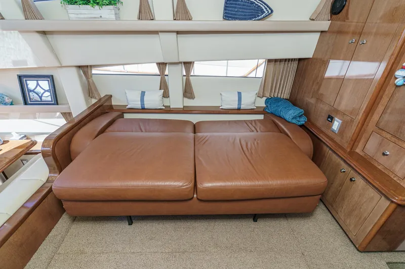 Slide: The Image of Luxurious interior of 2007 Carver 43 Motor Yacht with brown leather seating. - 33