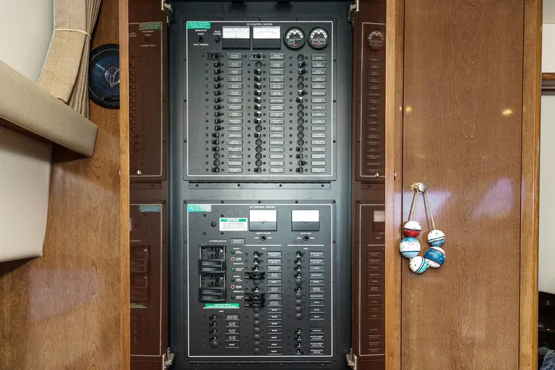 Slide: The Image of Electrical control panel inside 2007 Carver 43 Motor Yacht, featuring switches and gauges. - 34