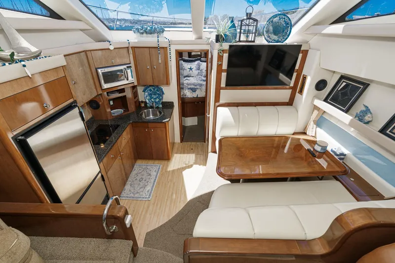 Slide: The Image of Luxurious interior of 2007 Carver 43 Motor Yacht with kitchen and seating area. - 38