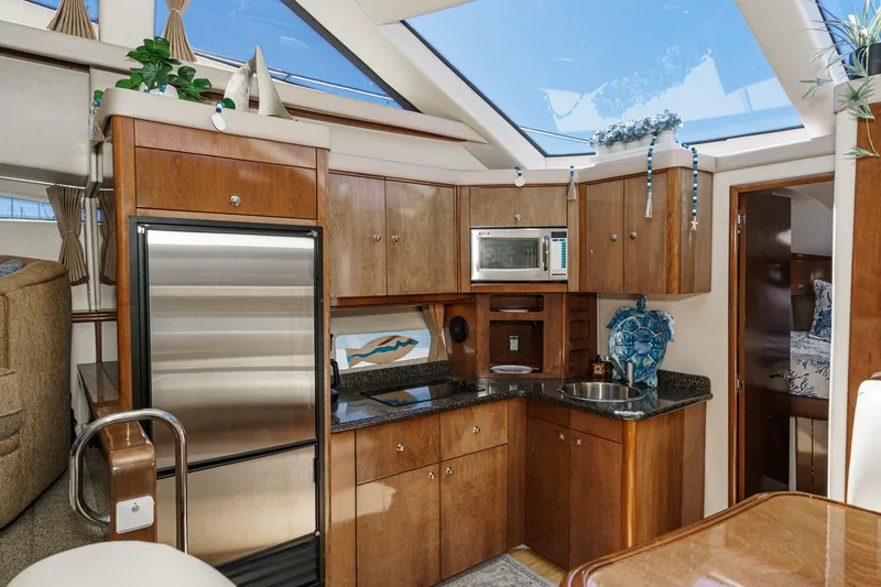Slide: The Image of Luxurious 2007 Carver 43 Motor Yacht kitchen with wood cabinetry and modern appliances. - 39