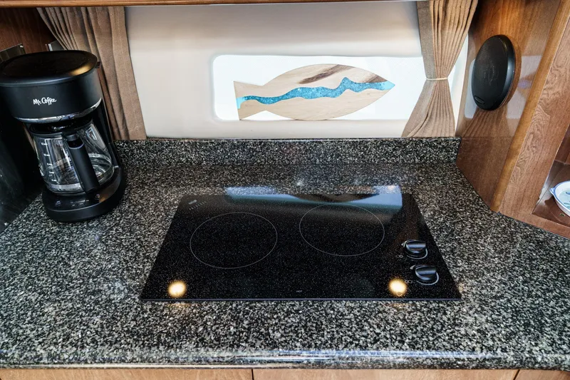 Slide: The Image of Granite countertop with stovetop and coffee maker in 2007 Carver 43 Motor Yacht kitchen. - 41