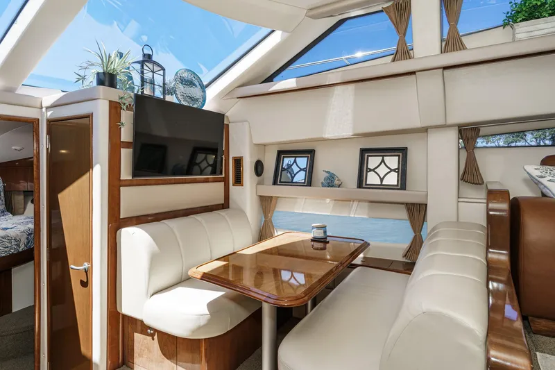 Slide: The Image of Luxurious interior of 2007 Carver 43 Motor Yacht with elegant dining area and skylight. - 44