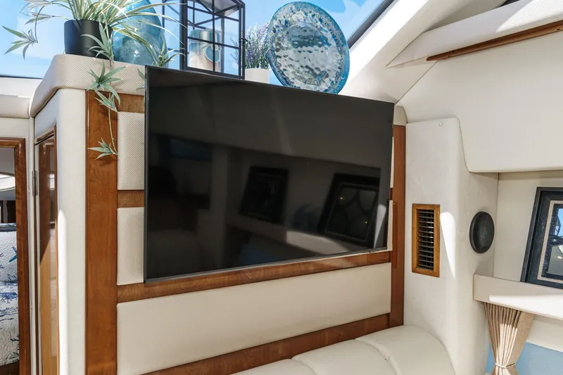 Slide: The Image of Interior of 2007 Carver 43 Motor Yacht with mounted TV and decorative plants. - 46
