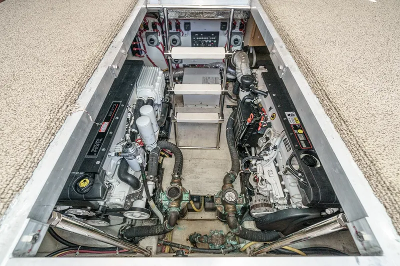 Slide: The Image of Engine room of a 2007 Carver 43 Motor Yacht, showcasing dual engines and mechanical components. - 57