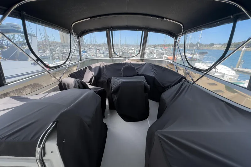 Slide: The Image of 2007 Carver 43 Motor Yacht interior with covered seating, docked at a marina. - 65