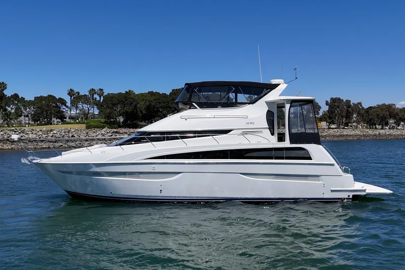 Slide: The Image of 2007 Carver 43 Motor Yacht cruising on a sunny day, surrounded by calm waters. - 7