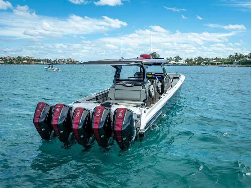 Slide: The Image of 2023 Nor-Tech 500 Sport boat with quad engines on clear blue water. - 11