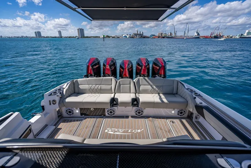 Slide: The Image of 2023 Nor-Tech 500 Sport boat with powerful engines and luxurious seating on open water. - 21