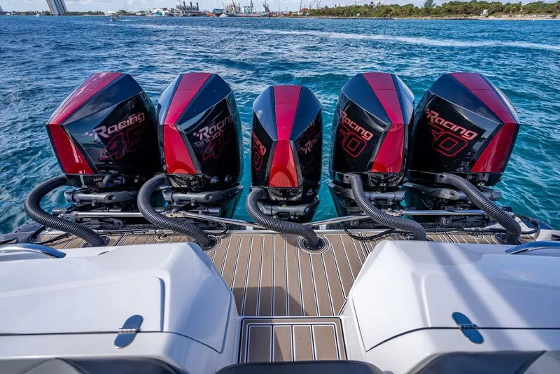 Slide: The Image of 2023 Nor-Tech 500 Sport boat with four powerful outboard engines on open water. - 25