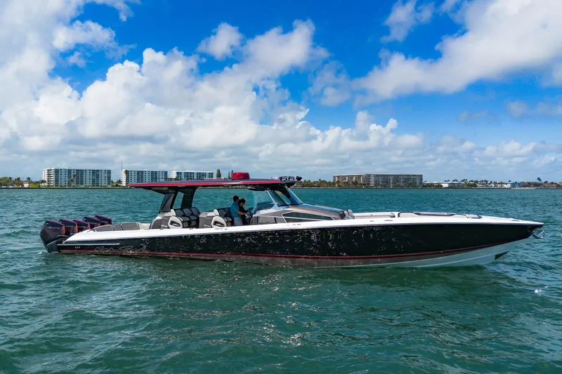 Slide: The Image of 2023 Nor-Tech 500 Sport Center Console boat cruising on open water under a blue sky. - 3