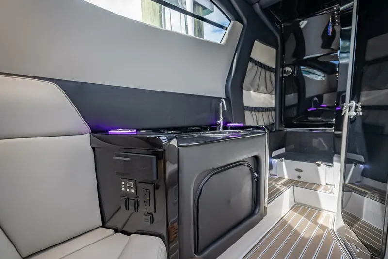 Slide: The Image of 2023 Nor-Tech 500 Sport interior with modern design, featuring seating, sink, and sleek finishes. - 38