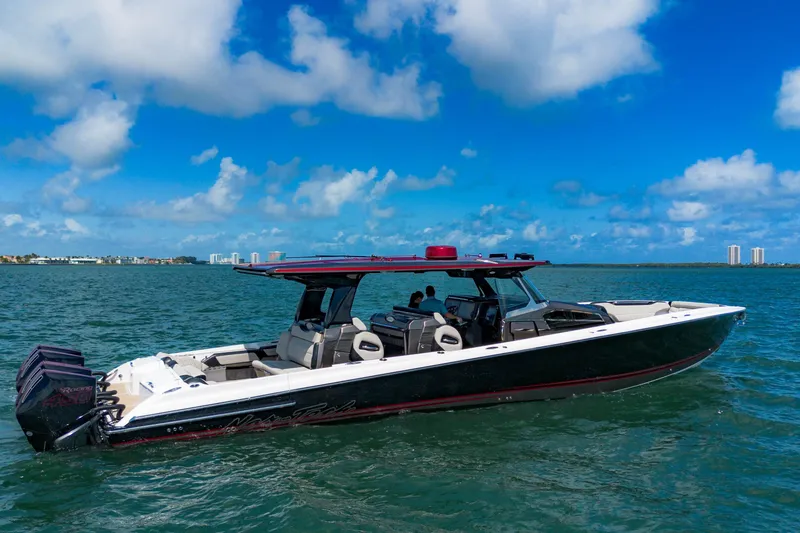 Slide: The Image of 2023 Nor-Tech 500 Sport Center Console boat cruising on open water under blue skies. - 4