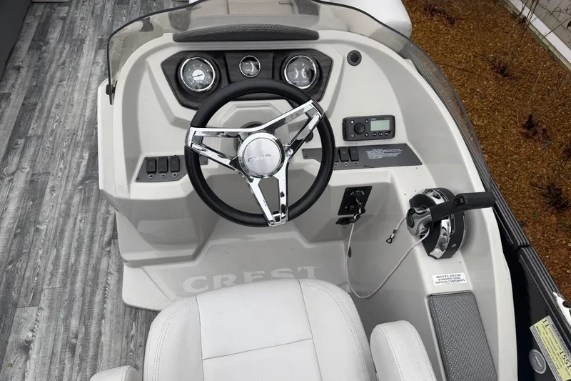 Slide: The Image of 2019 Crest II SLC LTD boat dashboard with steering wheel and controls. - 12