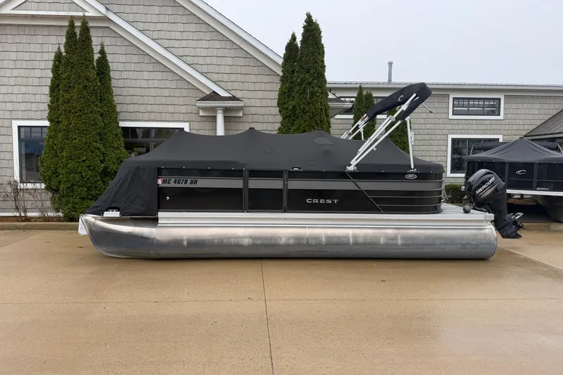 Slide: The Image of 2019 Crest II SLC LTD pontoon boat with cover, parked outside a building. - 18