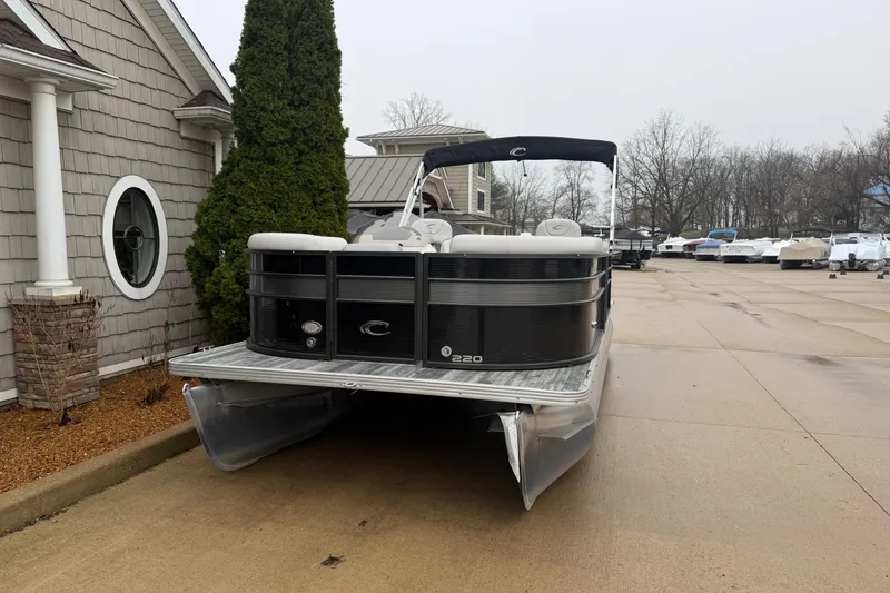 Slide: The Image of 2019 Crest II SLC LTD pontoon boat parked near a building on a cloudy day. - 3