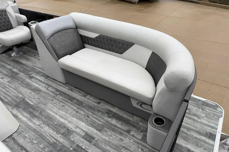 Slide: The Image of 2019 Crest II SLC LTD boat interior with gray and white seating on wood-patterned flooring. - 5