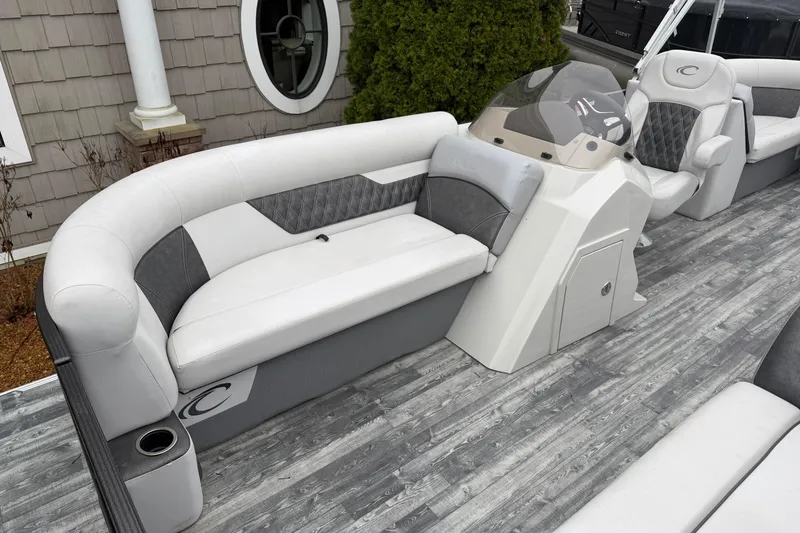 Slide: The Image of 2019 Crest II SLC LTD pontoon boat interior with gray seating and helm. - 6