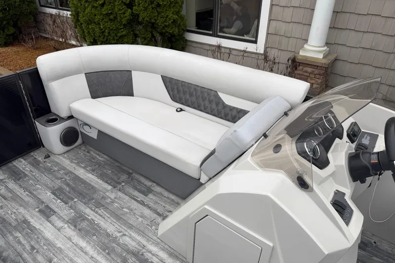 Slide: The Image of 2019 Crest II SLC LTD boat interior with white seating and modern dashboard. - 7
