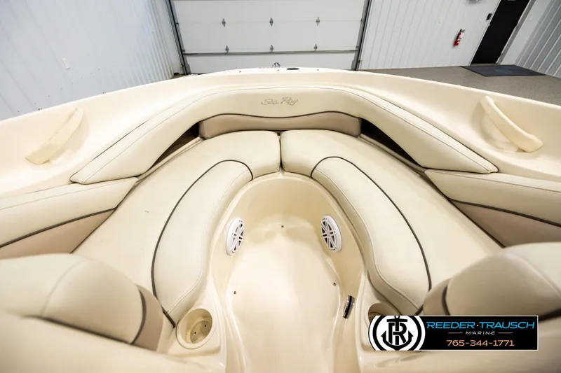 Slide: The Image of Interior view of a 2003 Sea Ray 200 Bow Rider boat with beige seating. - 14
