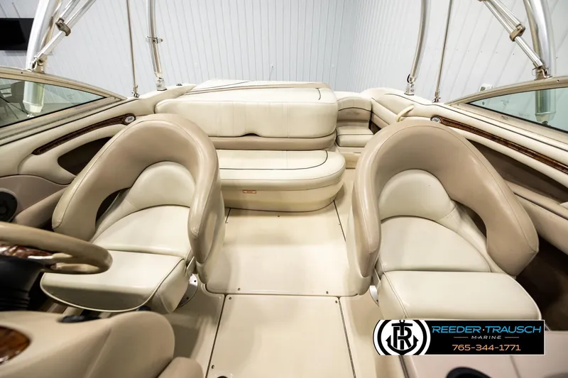 Slide: The Image of Interior of 2003 Sea Ray 200 Bow Rider boat with beige seating and steering wheel. - 16