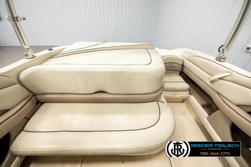 Slide: The Image of 2003 Sea Ray 200 Bow Rider interior with beige seating and sleek design. - 17