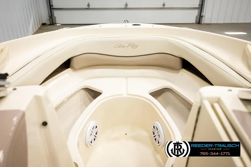 Slide: The Image of 2003 Sea Ray 200 Bow Rider interior with beige seating and speakers. - 19