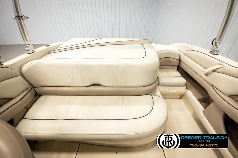 Slide: The Image of Interior seating of a 2003 Sea Ray 200 Bow Rider boat, featuring beige upholstery. - 20