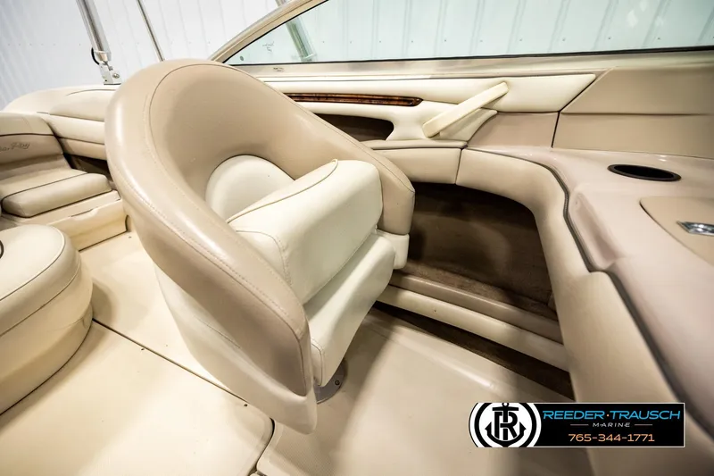 Slide: The Image of Interior of a 2003 Sea Ray 200 Bow Rider boat with beige seating. - 24