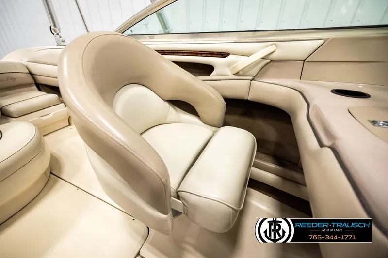 Slide: The Image of Interior of a 2003 Sea Ray 200 Bow Rider boat, featuring beige seating and sleek design. - 25