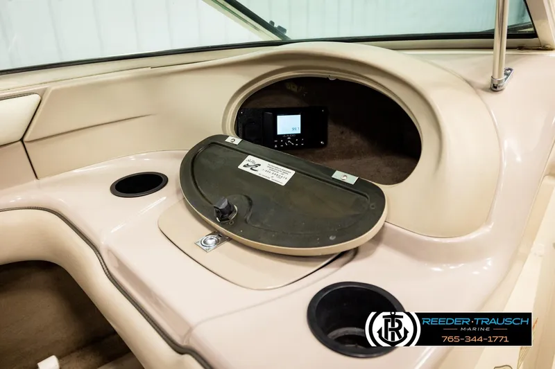 Slide: The Image of 2003 Sea Ray 200 Bow Rider dashboard with storage compartment and cup holder. - 30