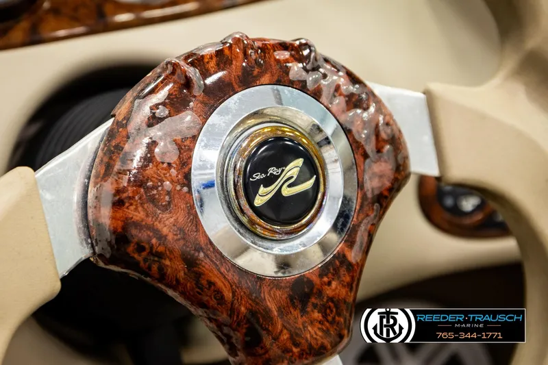 Slide: The Image of Close-up of a 2003 Sea Ray 200 Bow Rider steering wheel with wood grain finish. - 35