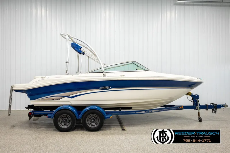 Slide: The Image of 2003 Sea Ray 200 Bow Rider boat on trailer in indoor showroom. - 4