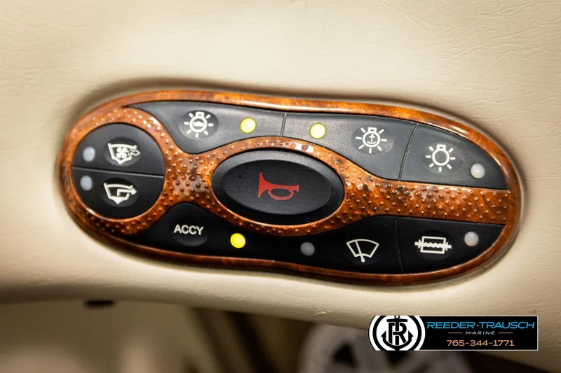 Slide: The Image of Control panel of a 2003 Sea Ray 200 Bow Rider boat with various function buttons. - 41