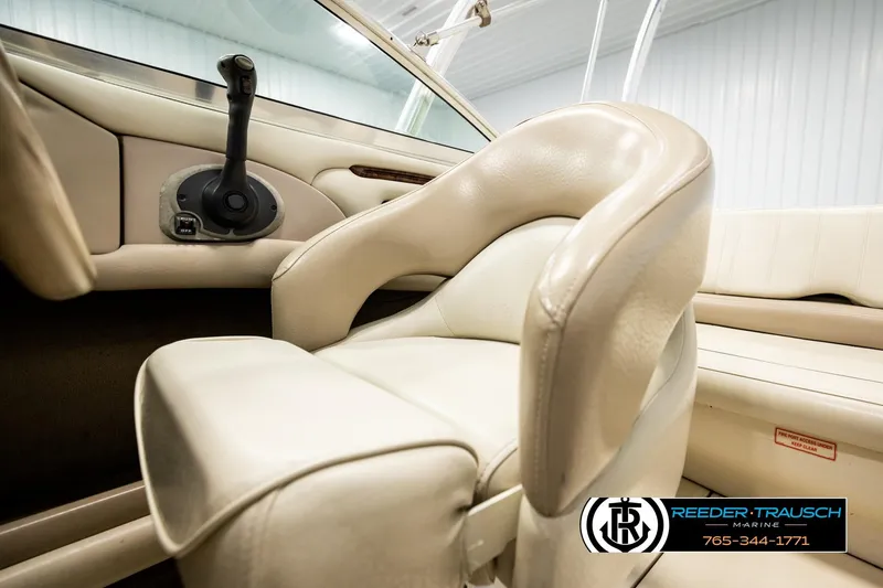 Slide: The Image of Interior of 2003 Sea Ray 200 Bow Rider boat with beige seating and control panel. - 43