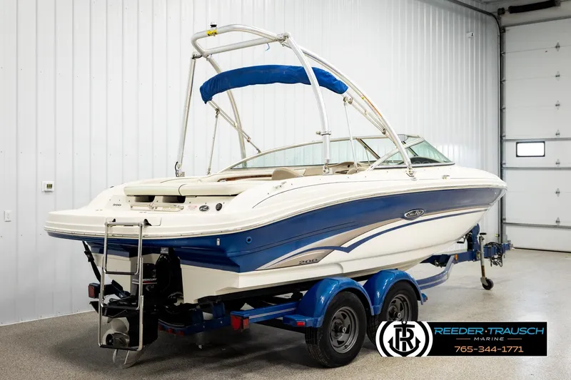 Slide: The Image of 2003 Sea Ray 200 Bow Rider boat on trailer in indoor storage. - 5