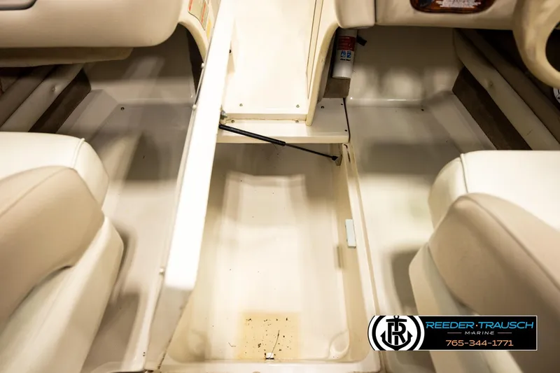 Slide: The Image of Interior view of a 2003 Sea Ray 200 Bow Rider boat, featuring seating and storage. - 51