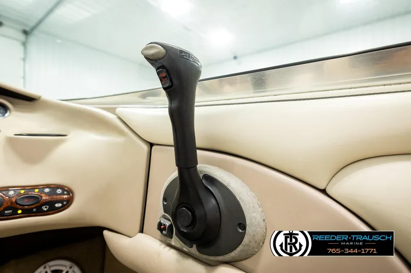 Slide: The Image of Throttle control of a 2003 Sea Ray 200 Bow Rider boat in a beige interior. - 52