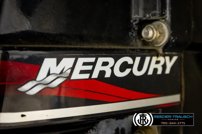 Slide: The Image of Close-up of Mercury engine logo on a 2003 Sea Ray 200 Bow Rider boat. - 55