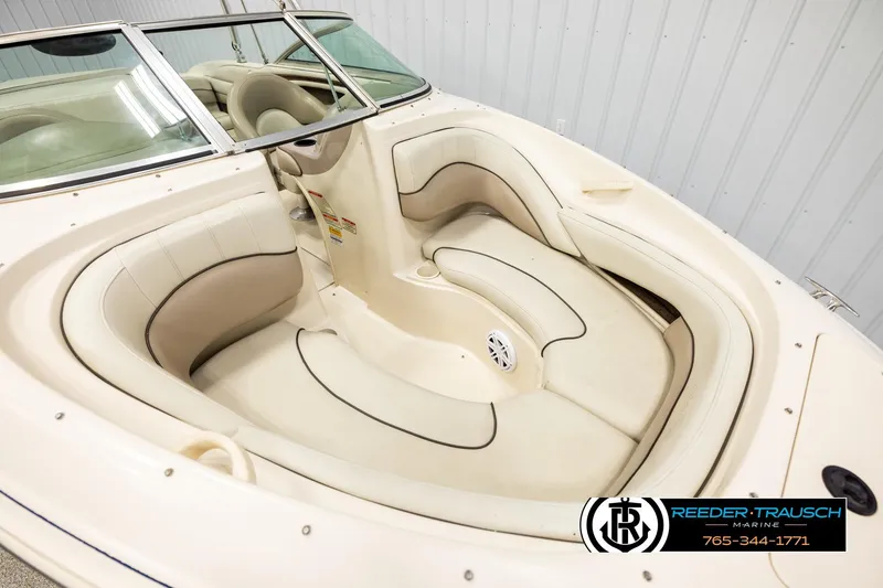 Slide: The Image of 2003 Sea Ray 200 Bow Rider boat interior with cream leather seating and steering wheel. - 8