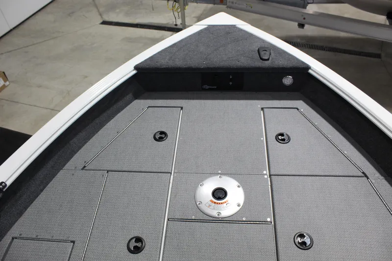 Slide: The Image of 2026 G3 Angler V18 FS boat deck with storage compartments and gray carpeting. - 3