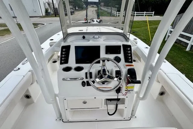 Slide: The Image of 2017 Robalo 246 Cayman boat dashboard with steering wheel and controls. - 10