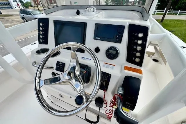 Slide: The Image of 2017 Robalo 246 Cayman boat dashboard with steering wheel and navigation controls. - 17