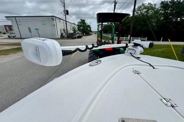 Slide: The Image of 2017 Robalo 246 Cayman boat with trolling motor on a street, near industrial buildings. - 18