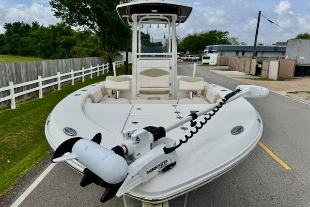 Slide: The Image of 2017 Robalo 246 Cayman boat with Minn Kota trolling motor on a road. - 6