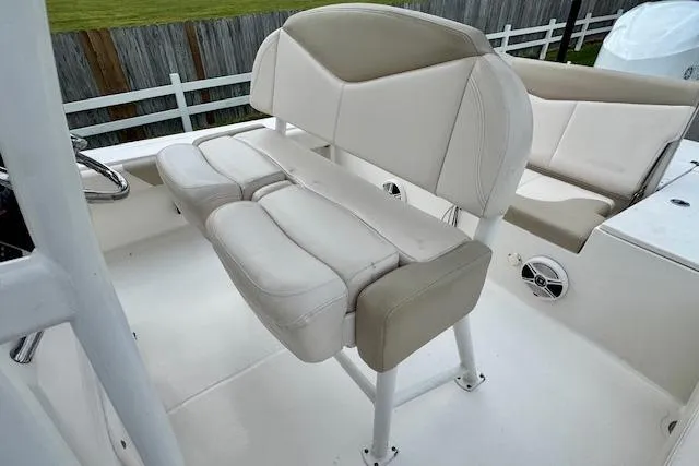 Slide: The Image of 2017 Robalo 246 Cayman boat interior with white cushioned seating. - 9