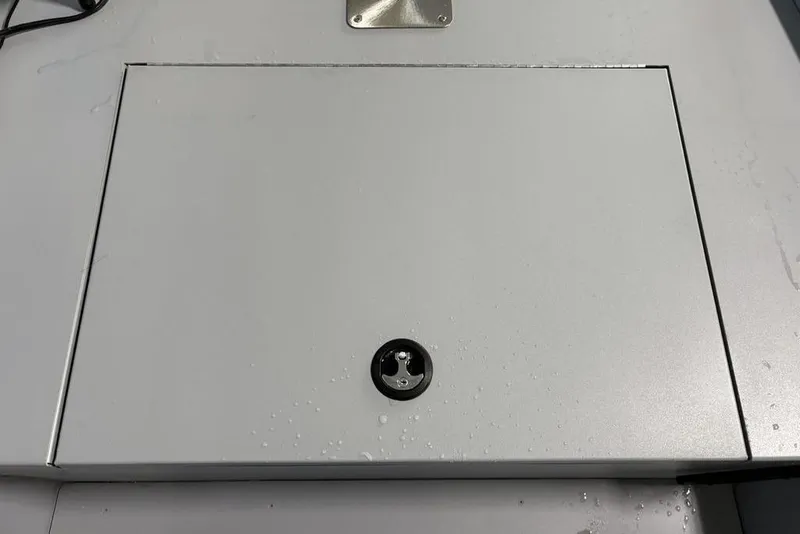 Slide: The Image of Closed storage compartment on 2026 Tracker Bass Tracker Classic CC boat, featuring a secure latch. - 5