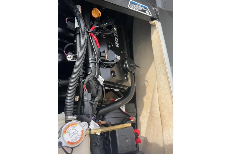 Slide: The Image of Engine compartment of 2022 Sea-Doo FishPro Sport 170, showcasing internal components and wiring. - 12