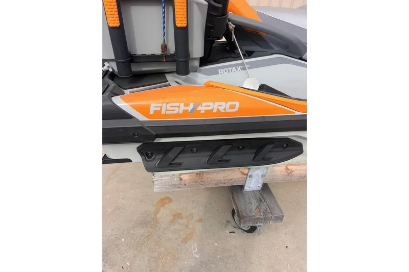 Slide: The Image of 2022 Sea-Doo FishPro Sport 170, orange and white design, on a trailer. - 8