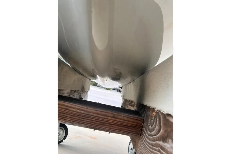 Slide: The Image of Underside view of 2022 Sea-Doo FishPro Sport 170 on a wooden trailer. - 9