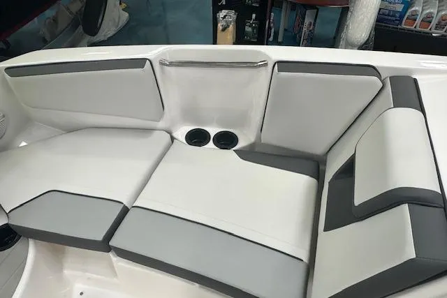 Slide: The Image of 2025 Yamaha Boats AR220 interior seating with gray and white upholstery. - 14
